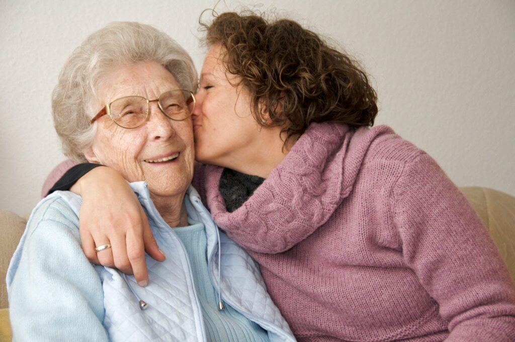 Woman kissing mother.